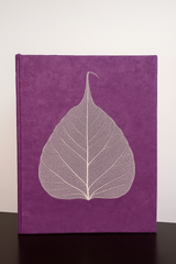 Handmade purple Lokta notebook with real Bodhi leaf design, crafted from tree-free Nepali paper.