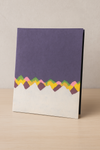 Front view of a handcrafted Lokta paper folder with a purple Himalayan mountain-inspired design on the cover