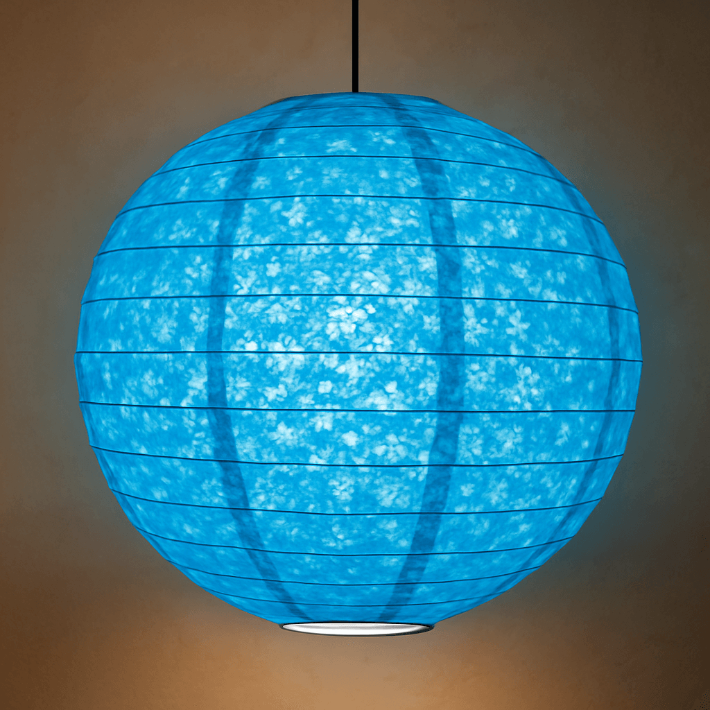 A vibrant blue spherical Lokta paper lantern with a subtle marbled texture is suspended from a black cord, softly illuminated against a neutral wall.