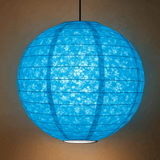 A vibrant blue spherical Lokta paper lantern with a subtle marbled texture is suspended from a black cord, softly illuminated against a neutral wall.