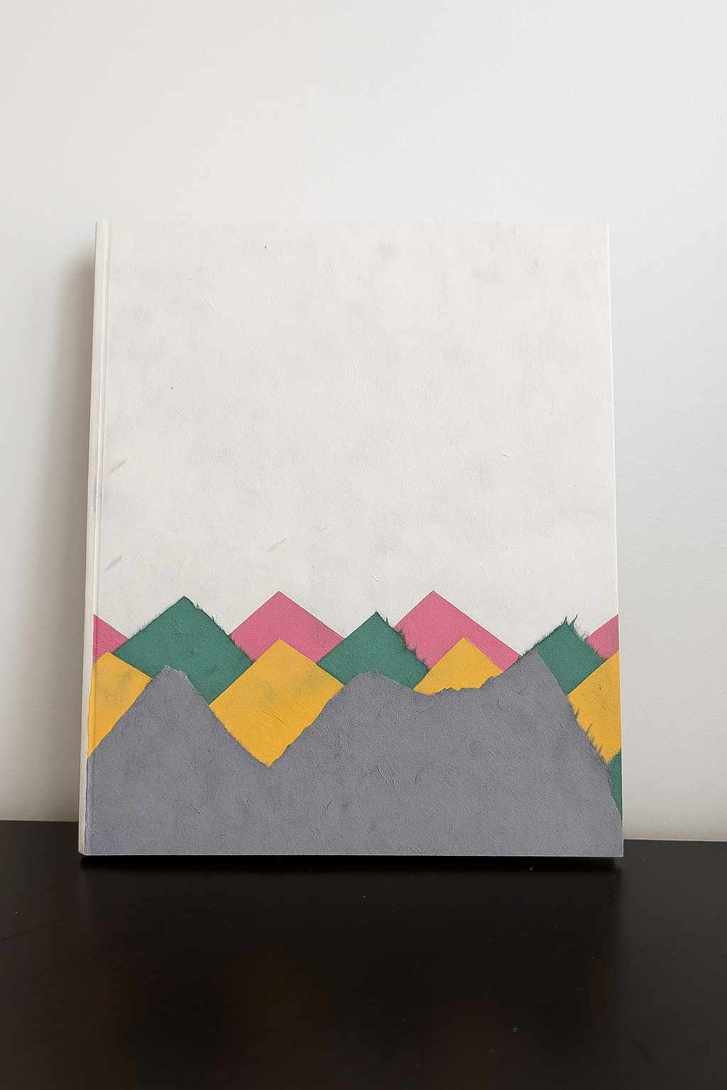 Handmade Lokta paper notebook with multicolor mountain-inspired design on natural white background